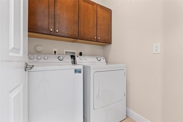 laundry area with cabinet space, washer and dryer, and baseboards