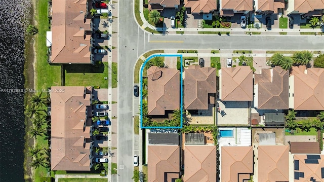 drone / aerial view with a residential view and a water view