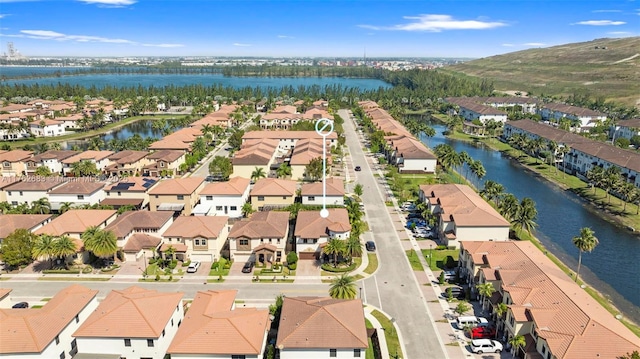 drone / aerial view with a residential view and a water view