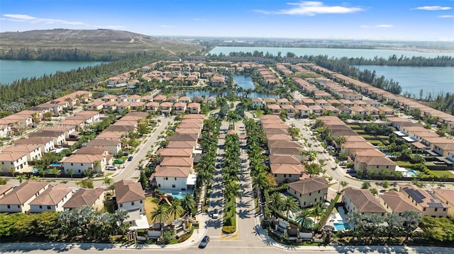 drone / aerial view featuring a residential view and a water view