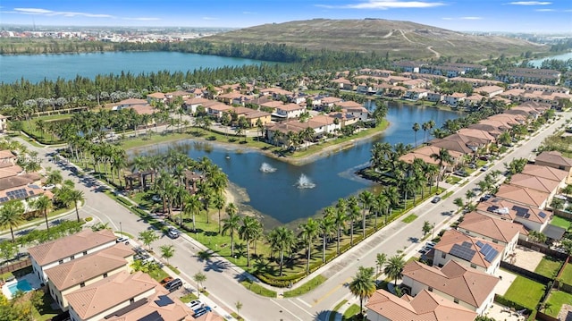 birds eye view of property with a residential view and a water view