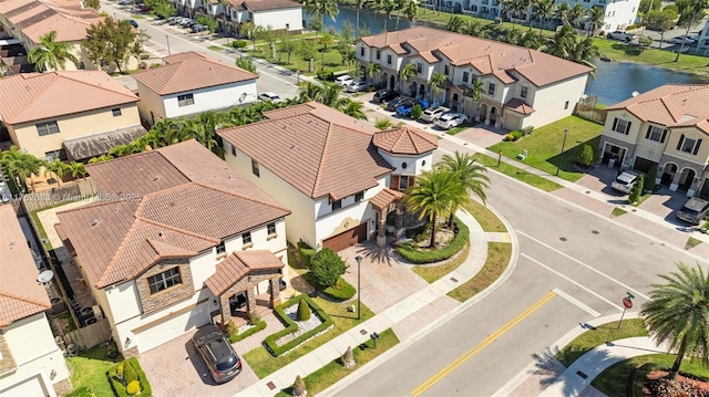 drone / aerial view with a residential view and a water view