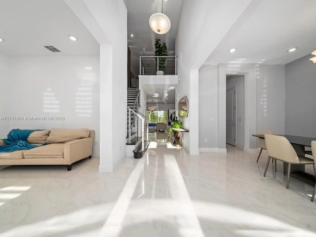 foyer with visible vents, baseboards, stairway, recessed lighting, and marble finish floor