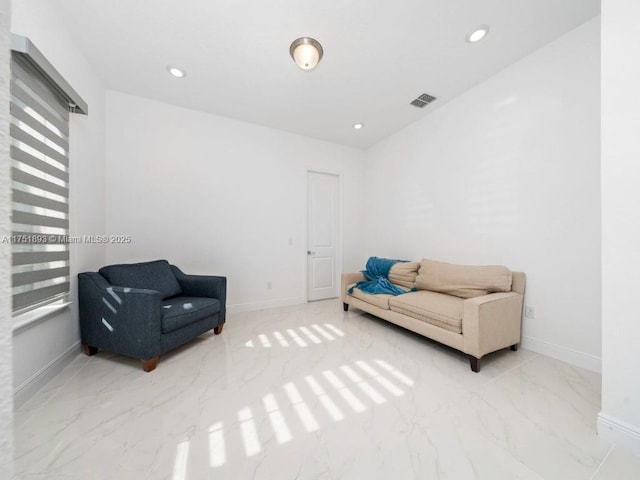 sitting room with recessed lighting, marble finish floor, and baseboards