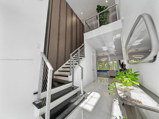 stairs featuring marble finish floor