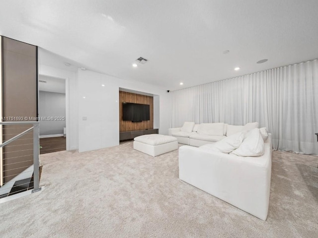 carpeted living room with recessed lighting and visible vents