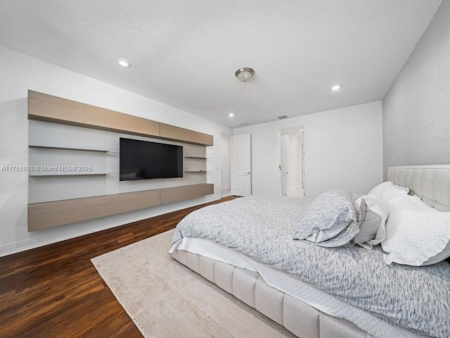 bedroom featuring recessed lighting and wood finished floors