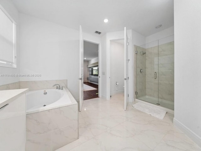 full bathroom featuring visible vents, a shower stall, toilet, a garden tub, and marble finish floor