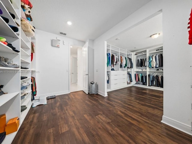 spacious closet featuring visible vents and wood finished floors