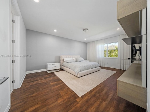 bedroom with dark wood finished floors, recessed lighting, and baseboards