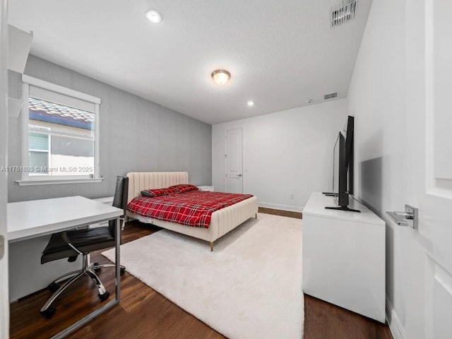 bedroom with dark wood finished floors, recessed lighting, baseboards, and visible vents