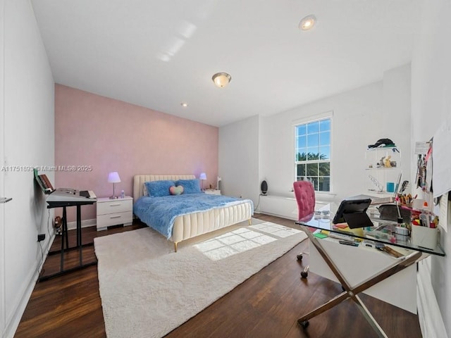 bedroom with dark wood-type flooring and recessed lighting