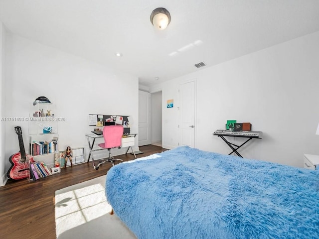 bedroom with wood finished floors and visible vents