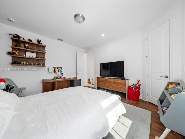 bedroom with recessed lighting, wood finished floors, and visible vents