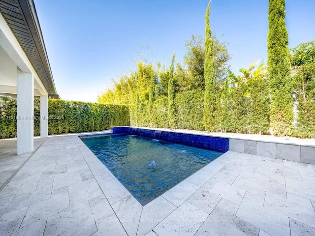 view of swimming pool with a fenced in pool and a patio