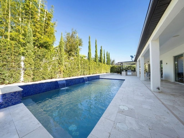 view of swimming pool featuring a patio area and a fenced in pool