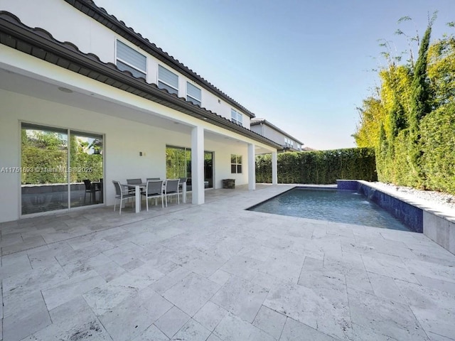 view of pool featuring outdoor dining space, a fenced in pool, and a patio