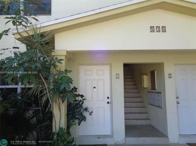 entrance to property featuring stucco siding