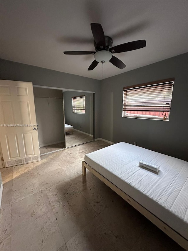 unfurnished bedroom with baseboards and ceiling fan