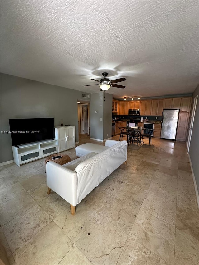 530 NE 15th Ct Unit 1, Fort Lauderdale, FL 33304 - living area featuring ceiling fan and a textured ceiling