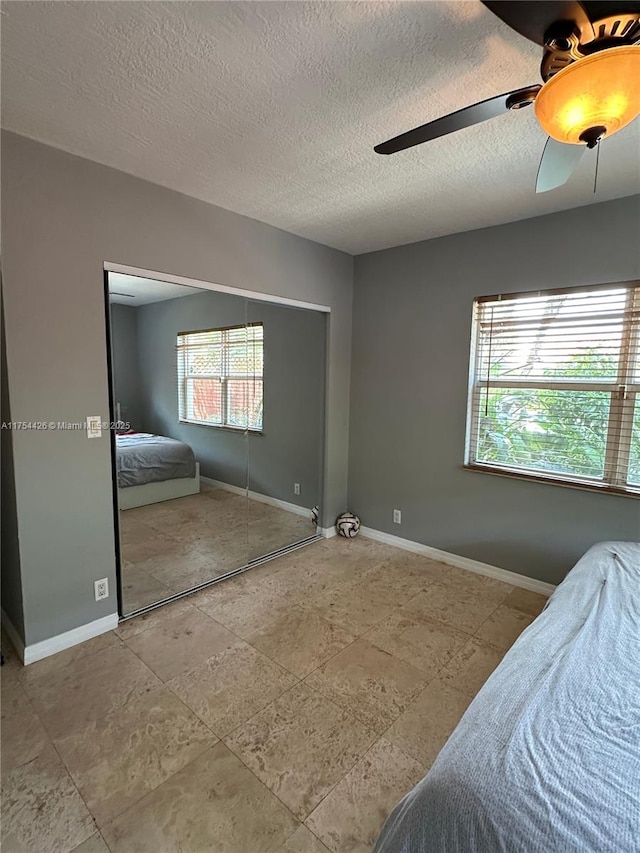 530 NE 15th Ct Unit 1, Fort Lauderdale, FL 33304 - bedroom featuring a textured ceiling, ceiling fan, and a closet