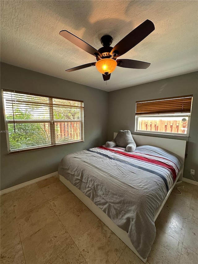 530 NE 15th Ct Unit 1, Fort Lauderdale, FL 33304 - bedroom featuring a textured ceiling and ceiling fan