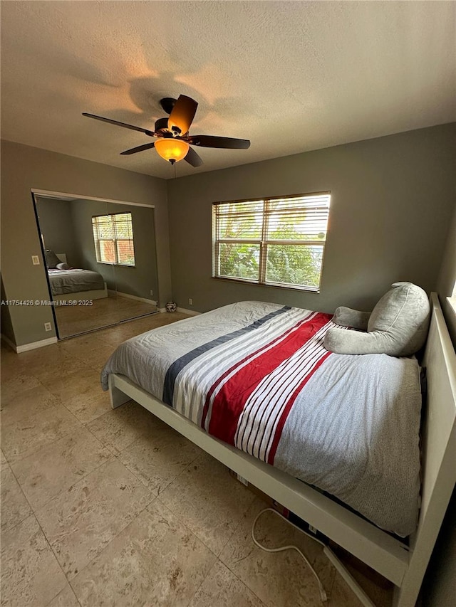 530 NE 15th Ct Unit 1, Fort Lauderdale, FL 33304 - bedroom with a textured ceiling and ceiling fan
