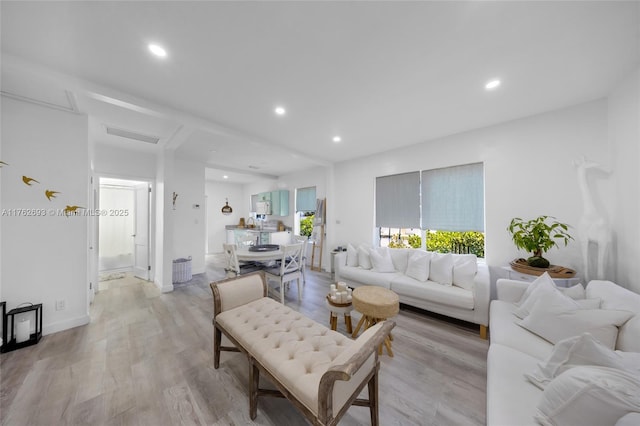 living room featuring light wood-style flooring and recessed lighting