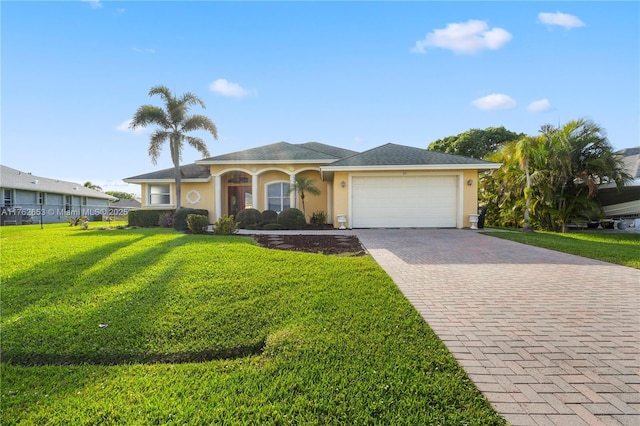 view of front of house with a front lawn, decorative driveway, an attached garage, and stucco siding