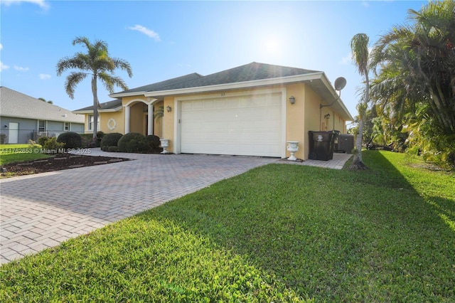 ranch-style home with stucco siding, decorative driveway, fence, an attached garage, and a front yard