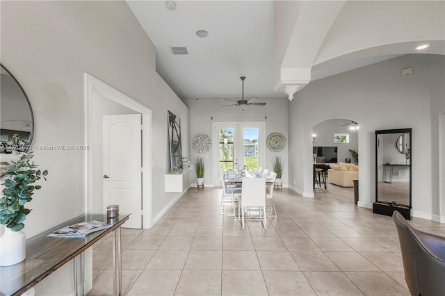 dining room with visible vents, ceiling fan, light tile patterned floors, french doors, and arched walkways