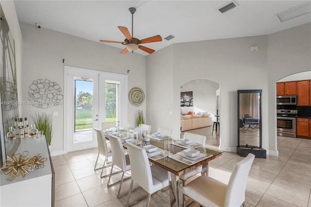 dining area with arched walkways, visible vents, french doors, and light tile patterned floors