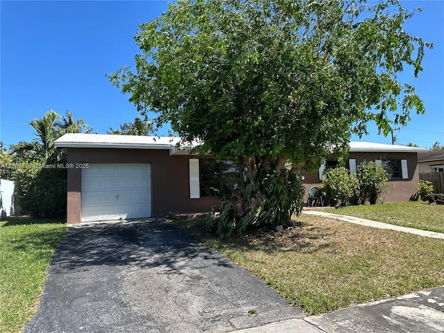 single story home with stucco siding, driveway, fence, a front yard, and a garage