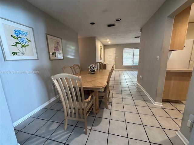 dining area with light tile patterned floors, visible vents, and baseboards