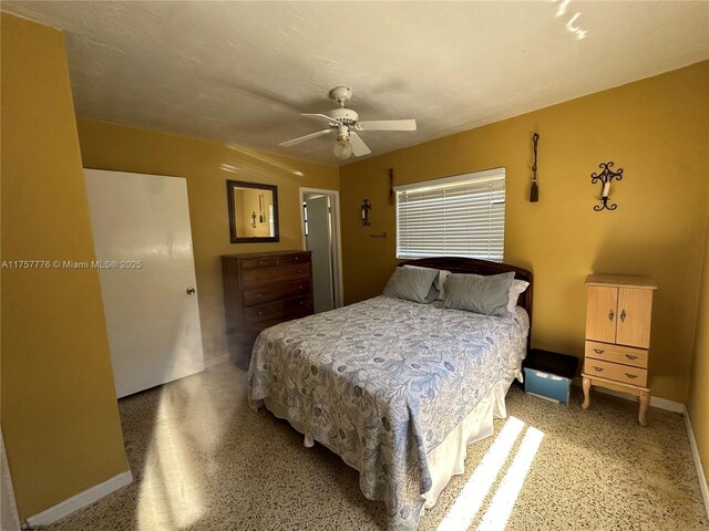 bedroom with a ceiling fan, speckled floor, and a textured ceiling