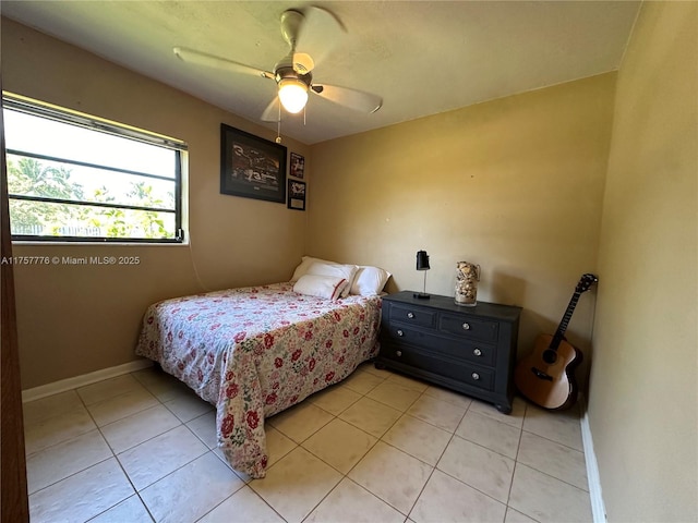 bedroom featuring ceiling fan, baseboards, and light tile patterned flooring