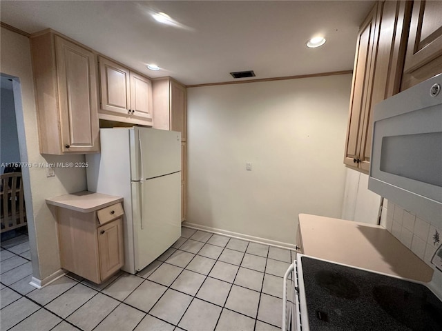 kitchen with white appliances, visible vents, light tile patterned flooring, ornamental molding, and light countertops