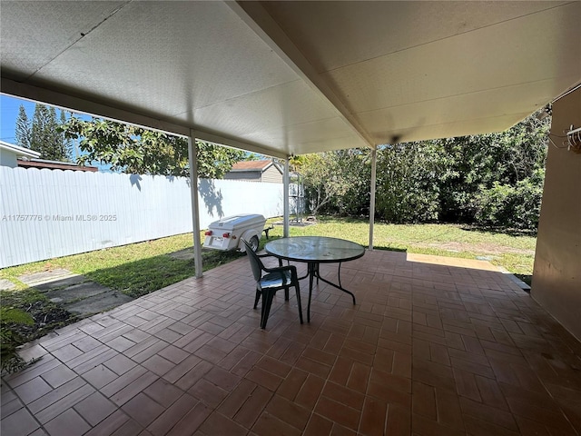 view of patio with outdoor dining space and fence