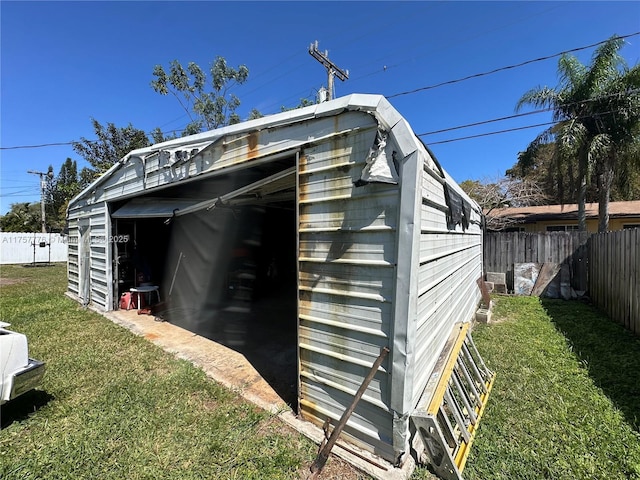 view of outdoor structure featuring a fenced backyard, a garage, and an outdoor structure