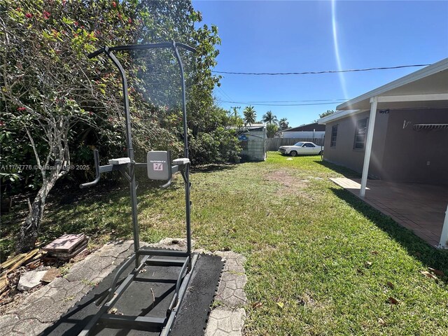 view of yard featuring a patio and fence