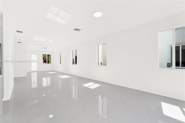 spare room with recessed lighting, visible vents, and marble finish floor