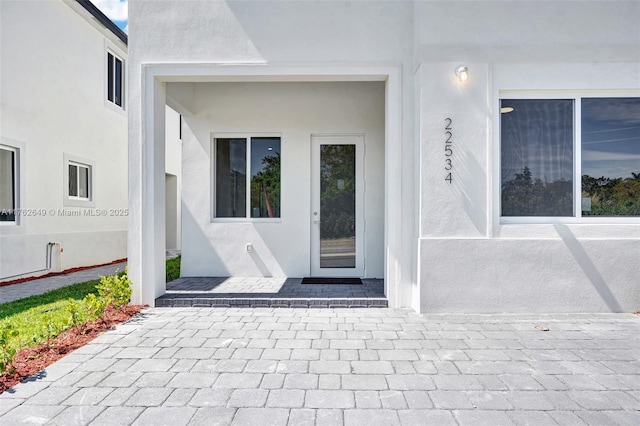 property entrance with stucco siding