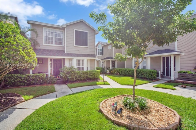 12140 Bruceton Way Unit 102, Orlando, FL 32828 - view of front of house featuring a shingled roof and a front lawn