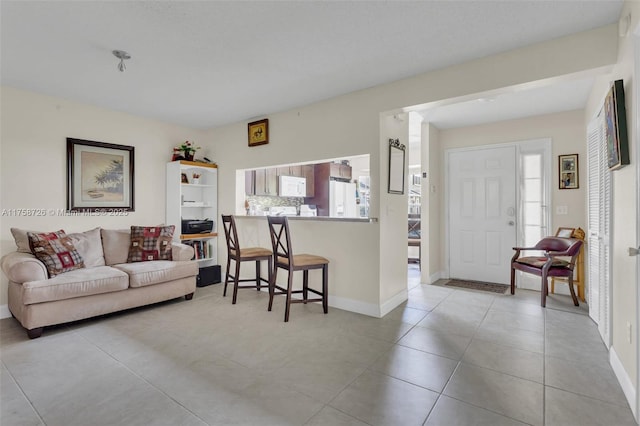 12140 Bruceton Way Unit 102, Orlando, FL 32828 - living area featuring baseboards and light tile patterned flooring