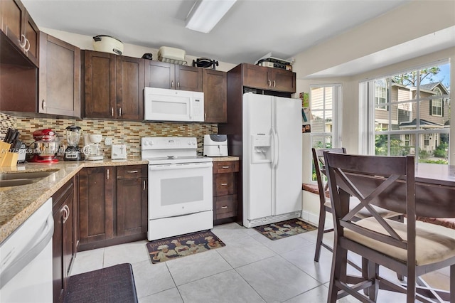 12140 Bruceton Way Unit 102, Orlando, FL 32828 - kitchen with tasteful backsplash, dark brown cabinets, and white appliances