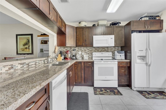 12140 Bruceton Way Unit 102, Orlando, FL 32828 - kitchen featuring a sink, backsplash, white appliances, light stone counters, and light tile patterned floors