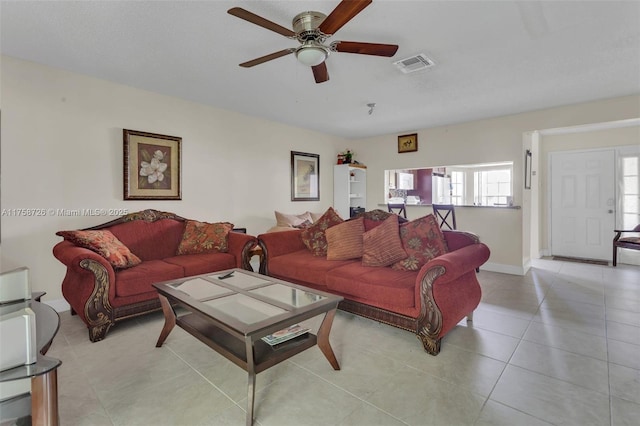 12140 Bruceton Way Unit 102, Orlando, FL 32828 - living area with baseboards, a ceiling fan, visible vents, and light tile patterned floors