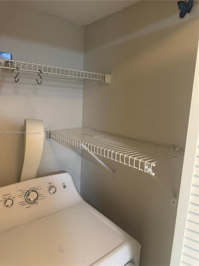 clothes washing area with laundry area and washer / dryer