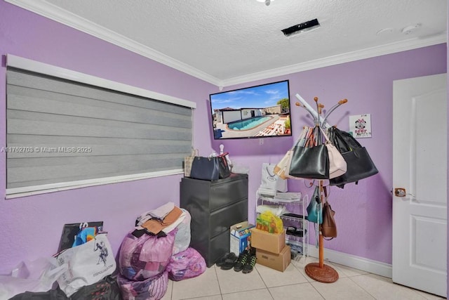 rec room featuring tile patterned flooring, a textured ceiling, baseboards, and ornamental molding