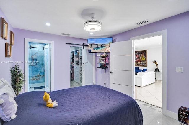 bedroom featuring a barn door, recessed lighting, baseboards, and visible vents